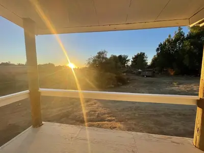 a view of the sunset through a window at Rejuvenation Cottage - Wine Country Tranquility in Temecula