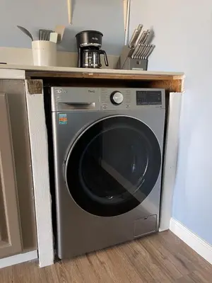 a washing machine under a counter in a kitchen at Rejuvenation Cottage - Wine Country Tranquility in Temecula