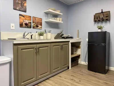 a kitchen with a sink and a refrigerator at Rejuvenation Cottage - Wine Country Tranquility in Temecula