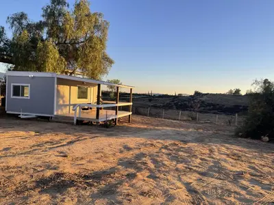 a tiny house sitting on top of a dirt field at Rejuvenation Cottage - Wine Country Tranquility in Temecula