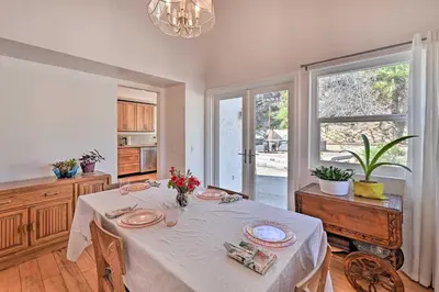 a dining room with a table with flowers on it at Spacious San Diego House with Yard and Patio! in San Diego