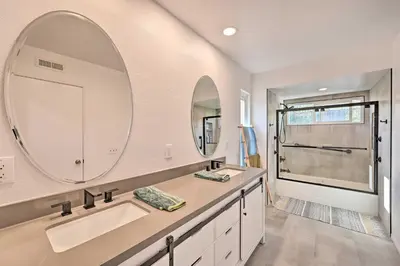 a bathroom with two sinks and a large mirror at Spacious San Diego House with Yard and Patio! in San Diego