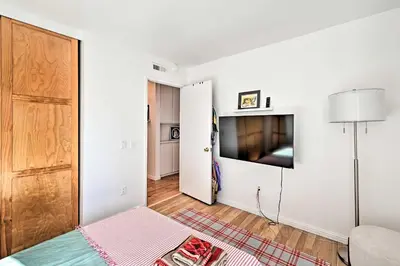 a living room with a bed and a tv at Spacious San Diego House with Yard and Patio! in San Diego