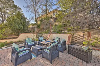 a patio with chairs and tables and a fence at Spacious San Diego House with Yard and Patio! in San Diego