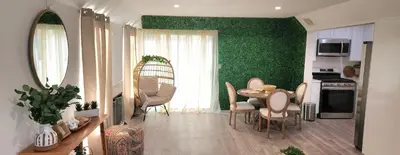 a living room with a table and chairs and a green wall at Gated Mountain Villa w/ Private Garage and King Bed in Lake Elsinore