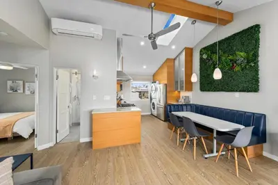 a kitchen and living room with a table and chairs at Modern Newly Renovated 2BR Apt in Heart of Ocean Beach in San Diego