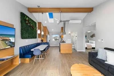 a living room and dining room with a blue couch at Modern Luxury 2BR Apt in Heart of Ocean Beach in San Diego