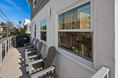 a row of chairs sitting on the side of a building at 7BD Family, Event Friendly, 2 blocks to Beach, Boardwalk in San Diego