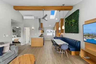 a living room and kitchen with a couch and a table at 7BD Family, Event Friendly, 2 blocks to Beach, Boardwalk in San Diego