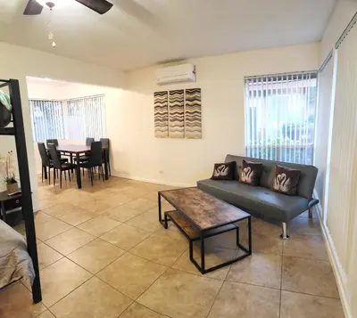 a living room with a couch and a table at Private, Spacious, 4x Queen, 300 MBPS Internet with Backyard! in Hemet