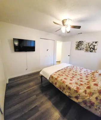 a bedroom with a bed and a ceiling fan at Private, Spacious, 4x Queen, 300 MBPS Internet with Backyard! in Hemet
