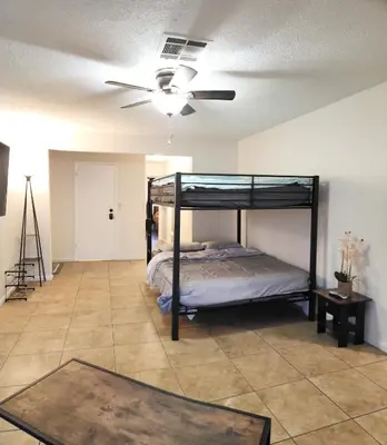 a bedroom with a bunk bed and a ceiling fan at Private, Spacious, 4x Queen, 300 MBPS Internet with Backyard! in Hemet