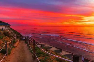 a painting of a sunset over the ocean at Steps To The BEST Beach . Surf . Spa . Main Street in Encinitas