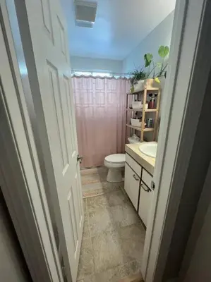 a bathroom with a toilet and a sink at Steps To The BEST Beach . Surf . Spa . Main Street in Encinitas