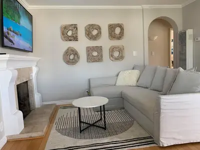 a living room with a couch and a table at Steps To The BEST Beach . Surf . Spa . Main Street in Encinitas