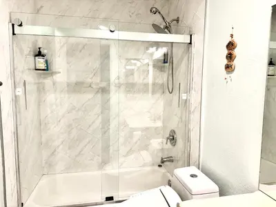 a white bathroom with a shower and a toilet at Artsy smart home near Downtown & Balboa Park in San Diego