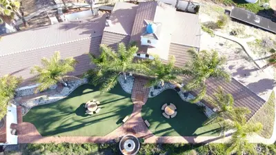 an overhead view of a building with palm trees at Private Home on 10 Acres - Heated Salt Pool & Jacuzzi, Mountain & City Views, Horseshoes, Basketball, BBQ, Golf Putting, Foosball, Croquet, Bose Stereo, White Cotton Bedding - Hilltop Hacienda, Pool Heat Optional in Jamul