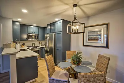 a kitchen and dining room with a table and chairs at Cozy-Chic Condo Walk to Beach and Park! in Dana Point