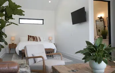 a bedroom with a bed and a tv on a wall at Hidden Hacienda in Temecula