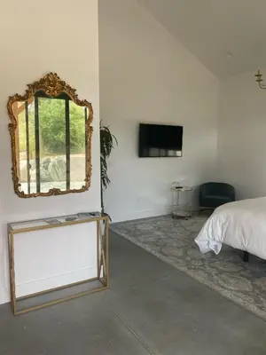 a bedroom with a bed and a mirror on the wall at Hidden Hacienda in Temecula