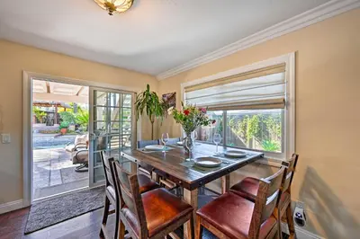 a dining room with a wooden table and chairs at Vista Home with Pool about 11 Mi to Tamarack State Beach in Vista
