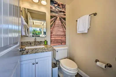 a bathroom with a toilet and a sink and a mirror at Vista Home with Pool about 11 Mi to Tamarack State Beach in Vista