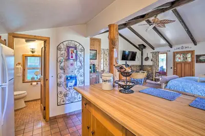 a kitchen and living room with a bedroom and a bed at Cozy Story Book Barn Cottage with Scenic View in Julian