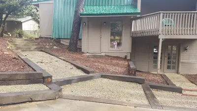 a house with steps leading into a yard with a porch at Julian House of Games in Julian