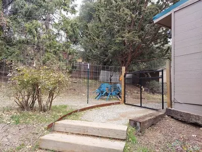 a fence with a gate in front of a yard at Julian House of Games in Julian