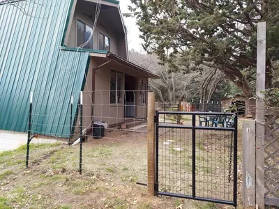 a house with a gate in front of a house at Julian House of Games in Julian