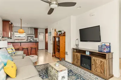 a living room with a couch and a flat screen tv at Beach Front Bungalow at Pacific Beach in San Diego