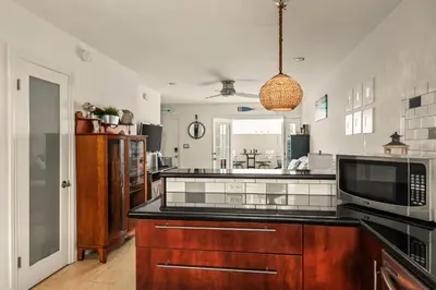 a kitchen with a sink and a microwave at Beach Front Bungalow at Pacific Beach in San Diego