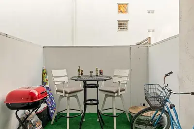 a table and chairs and a bike in a room at Beach Front Bungalow at Pacific Beach in San Diego