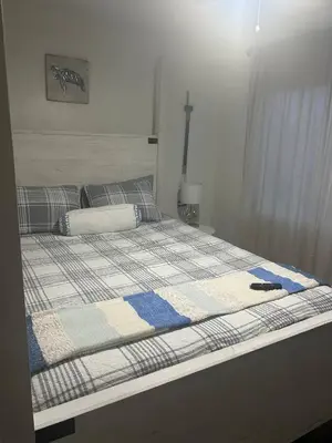 a bed with a quilt on it in a bedroom at Beach Front Bungalow at Pacific Beach in San Diego