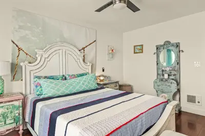 a bedroom with a large bed with a colorful blanket at Beach Front Bungalow at Pacific Beach in San Diego