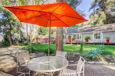 a table with an orange umbrella in a yard at Fallbrook Vacation Rental 3 Mi to Wineries! in Fallbrook
