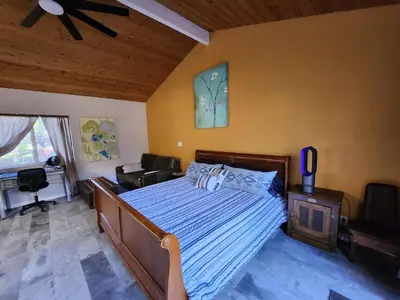 a bedroom with a bed and a ceiling fan at On Site Parking King Master Suite UCSD Walk in San Diego