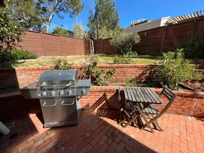 a grill and a picnic table in a backyard at On Site Parking King Master Suite UCSD Walk in San Diego