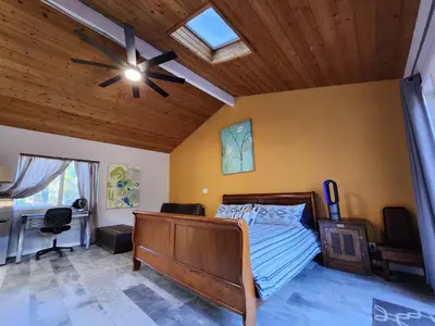 a bedroom with a bed and a ceiling fan at On Site Parking King Master Suite UCSD Walk in San Diego