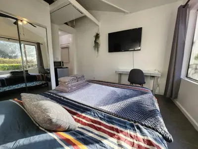 a bedroom with a bed and a tv on the wall at Private Room1 Own Bath Own Entry Shared Kitchen Walk to UCSD in San Diego