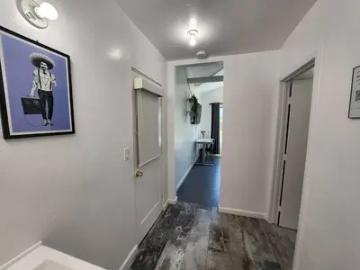 a hallway with a picture of a woman on the wall at Private Room1 Own Bath Own Entry Shared Kitchen Walk to UCSD in San Diego