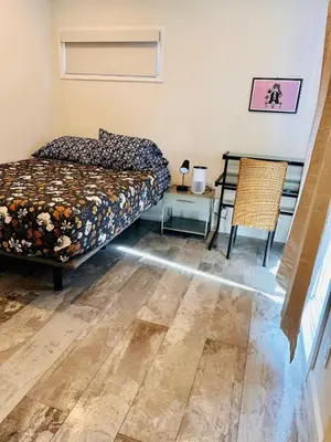 a bedroom with a bed and a table with a chair at Private Room0 Own Bath Own Entry Shared Kitchen Walk to UCSD in San Diego