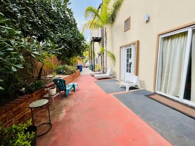 a patio with chairs and tables and a building at Private Room0 Own Bath Own Entry Shared Kitchen Walk to UCSD in San Diego