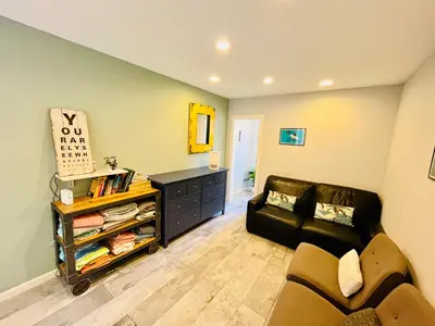a living room with a couch and a table at Private Room2 Own Entry Shared Bath One Guest Walk to UCSD in San Diego