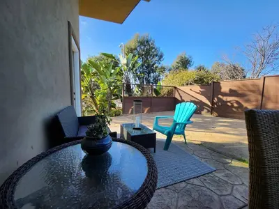 a patio with a glass table and two chairs at Private Room2 Own Entry Shared Bath One Guest Walk to UCSD in San Diego