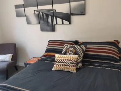 a bedroom with a bed with pillows on it at Private Room3 Own Entry Shared Bath One Guest Walk to UCSD in San Diego