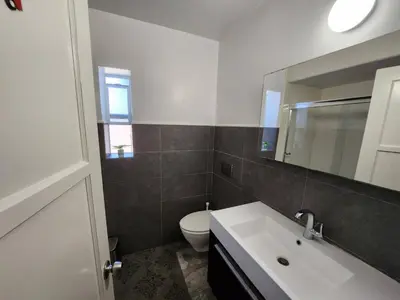 a bathroom with a sink and a toilet and a mirror at Private Room3 Own Entry Shared Bath One Guest Walk to UCSD in San Diego