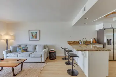 a white living room with a couch and a table at Bright Townhome in Carlsbad 1 Mile to Beach! in Carlsbad