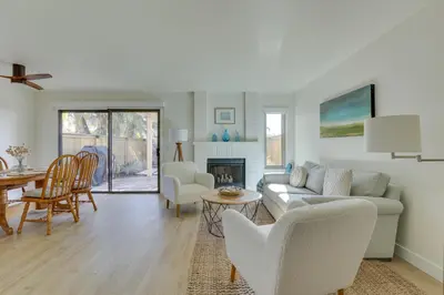 a living room with white furniture and a fireplace at Bright Townhome in Carlsbad 1 Mile to Beach! in Carlsbad
