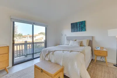a bedroom with a bed and a balcony at Bright Townhome in Carlsbad 1 Mile to Beach! in Carlsbad